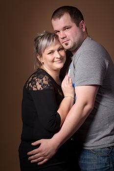 Studio shoot of beautiful fashion xxl woman with her husband, happy couple love concept