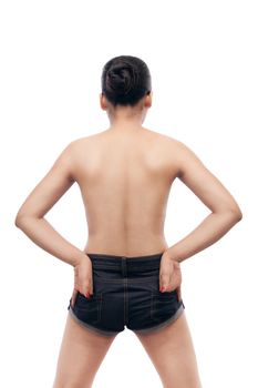 Young indian woman showing her smooth skinned back in blue jeans with their hands in back pocket isolated over white background