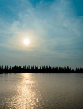 The Silhouette Pine Tree and Reflection Sunset on River in Thailand.