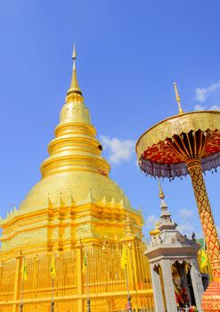 The Golden Pagoda and blue Sky at Wat Phra Tad Haripunchai,Thailand.