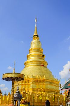 The Golden Pagoda and blue Sky at Wat Phra Tad Haripunchai,Thailand.