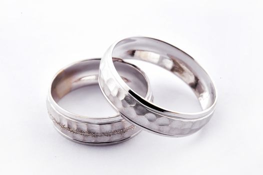 Pair of handcrafted gold wedding rings  on white background