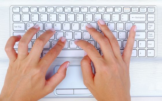 Keyboard Typing.female texting on a white laptop keyboard