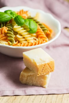 Italian pasta with basil and parmesan cheese, served on a white plate