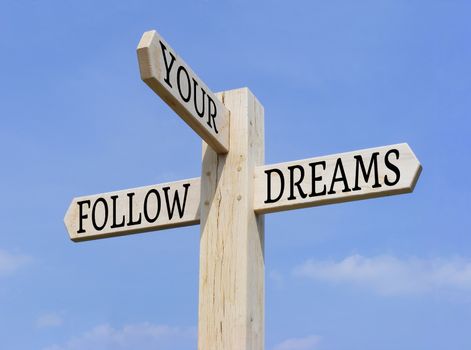 Signpost with the words "Follow Your Dreams" over a blue sky background