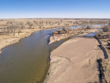 aerial view of South Platte River in eastern Colorado below Platteville, a typical winter scenery with exposed sandbars