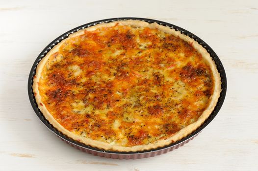 Round cheese tart on white background horizontal