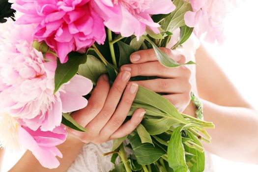 Beautiful bouquet of rose peonies in woman's hands