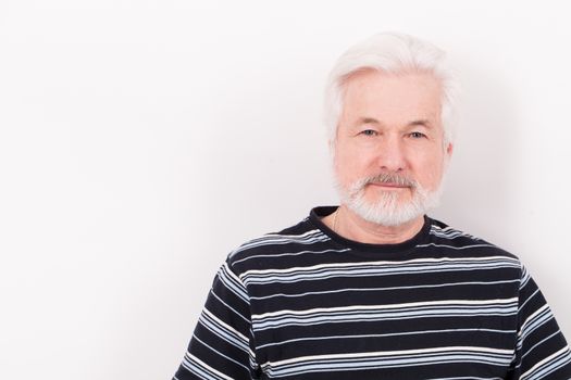 Handsome elderly man with grey beard isolated over white background