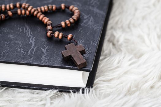 Christian cross necklace on Holy Bible book, Jesus religion concept as good friday or easter festival