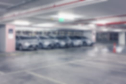 Abstract blur background of Vacant or empty space of car parking lot at night, shallow depth of focus