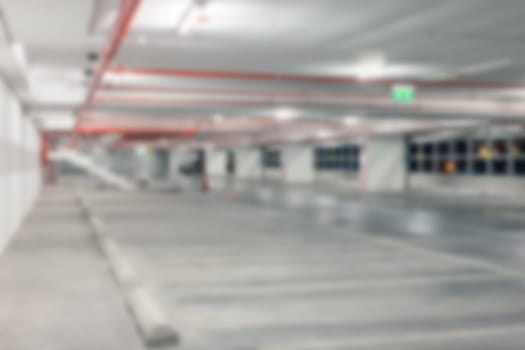 Abstract blur background of Vacant or empty space of car parking lot at night, shallow depth of focus