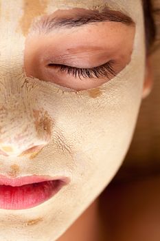 Half face portrait of beautiful indian woman with closed eyes and having face mask of calamine