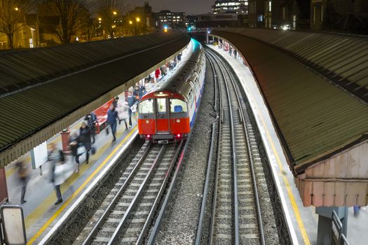 Britain; British; England; English; Europe; European; GB; Great Britain; UK; United Kingdom; above; blur; city; commuting; dark; evening; famous; high angle; late; motion; motion blur; movement; night; platform; public; rail; speed; subway; tracks; train; transport; transportation; tube; underground;