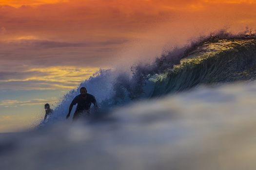 Colored Ocean Wave Falling Down at Sunset Time.