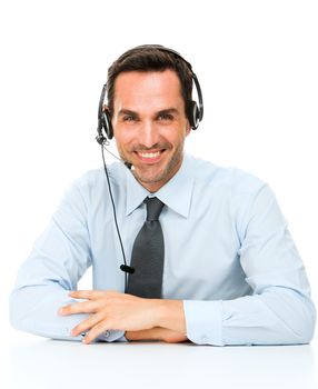 Portrait of a smiling man with headset leaning on his desk