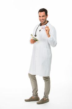 Full length portrait of a male doctor with stethoscope, smiling at camera and counting money
