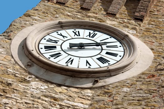 Clock tower detail in Passignano sul Trasimeno, small town on the homonym lake in the italian region of Umbria.