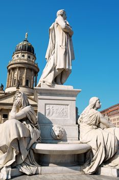 Detail of the French Dome and the monument to german poet Friedrich Schiller in Gendarmenmarkt Square in Berlin.
