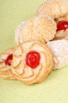 Close-up of assorted sicilian almond pastries decorated with candies cherries, icing sugar and granulated sugar. Selective focus.