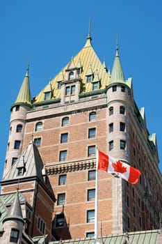 View of the historical Chateau Frontenac in old Quebec City and Canadian Flag