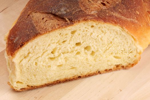 Freshly baked bread from Apulia on a wooden cutting board.