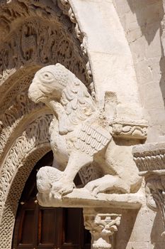 Detail of the portal of Ruvo di Puglia Cathedral in the southeast italian region of Apulia. The simple but elegant facade shows a lot of statues with vegetal, animal and human details. The Cathedral was dedicated to Santa Maria Assunta and was built between 12th and 13th century.