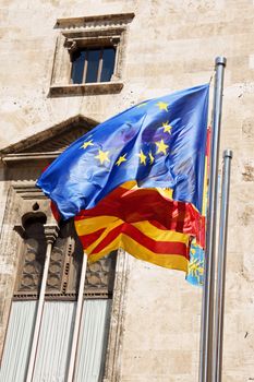 European Union, Spain and Valencia flags in front of Palau de la Generalitat in Valencia, Spain.