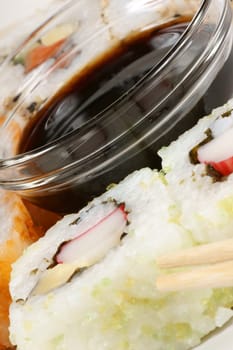 Close-up of Maki sushi rolls served on a plate with soy sauce. Selective focus.