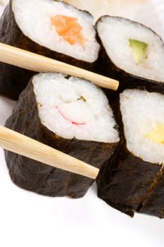 Close-up of sushi on a white tray and wooden chopsticks. Selective focus. With copy space.