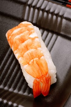 Close-up of a piece of sushi with shrimp.