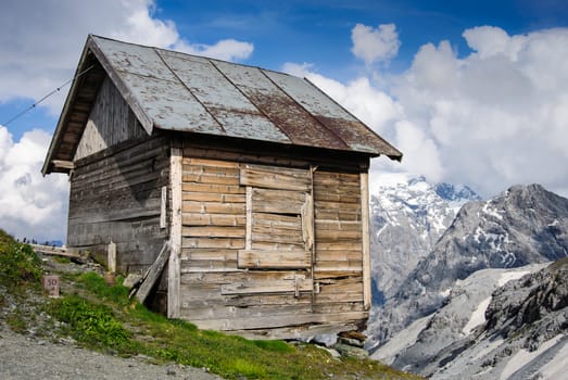 Alpine shed in a summer sunny day at the stelvio pass