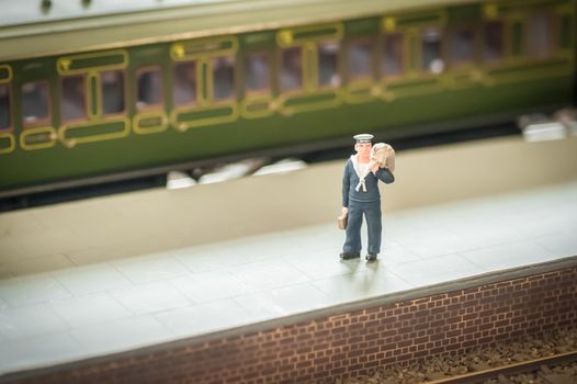 miniature model of a sailor alone on a railroad platform - shallow d.o.f.