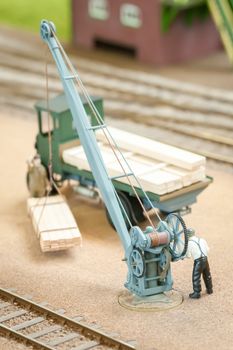 miniature figure loading wood with a hoist