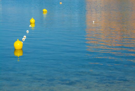 Yellow buoys. Plastic buoys on blue Mediterranean sea, Majorca, Balearic islands, Spain.