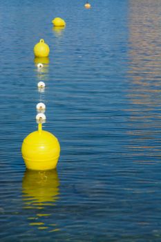 Yellow buoys. Plastic buoys on blue Mediterranean sea, Majorca, Balearic islands, Spain.