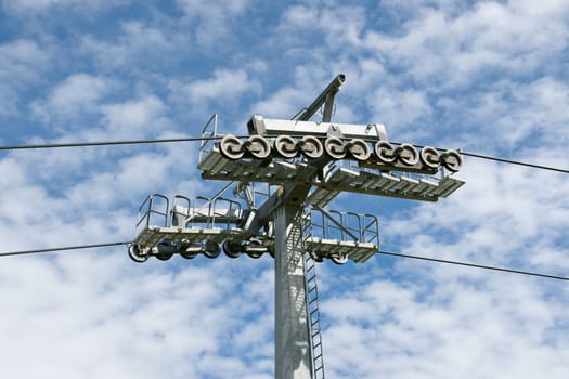 Cableway and pylon over a blue sky with clouds