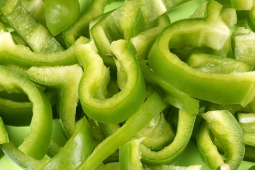 Organic background made of green bell pepper slices