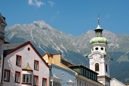 Glimpse of Innsbruck the capital town of the state of Tyrol in Austria. Typical colored houses and church between high mountains