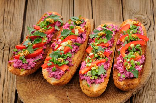 Vegetarian sandwiches with beetroot, bell pepper, parsley and scallion on wooden background horizontal