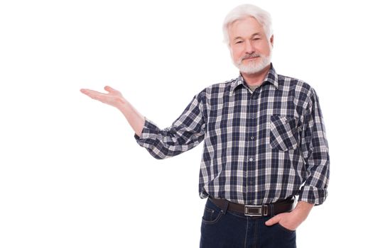 Handsome elderly man with grey beard shows on something isolated over white background