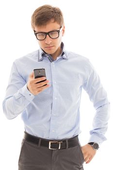 Handsome man in a blue shirt and glasses holds a cellphone