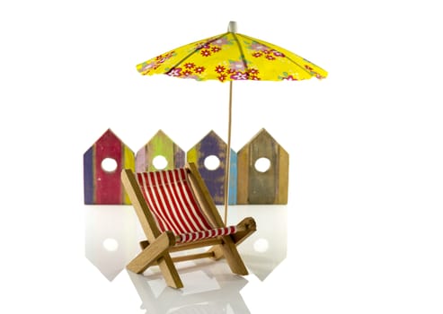 yellow beach umbrella with chair and wooden beach houses