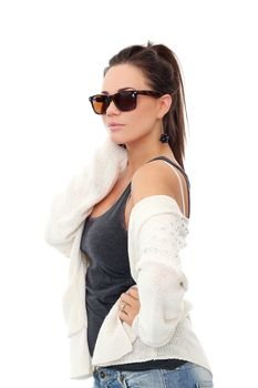 Portrait of a beautiful girl with brown hair who is posing in long white blouse and sunglasses over a white background
