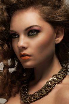 Beautiful caucasian woman with curls and evening makeup