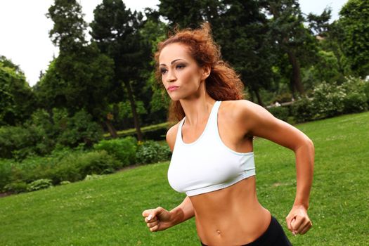 Beautiful middleaged caucasian woman working out in a park