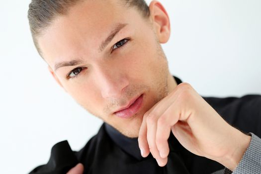 Portrait of a handsome man in a suit with a beard who is posing over a white background