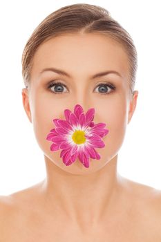 Beautiful young natural caucasian woman with flower in her mouth