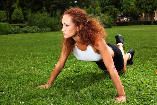 Beautiful middleaged caucasian woman working out in a park