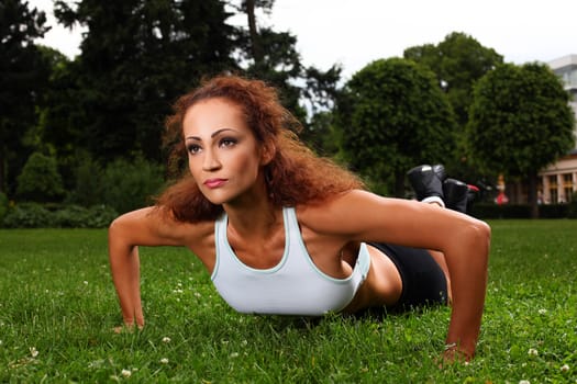 Beautiful middleaged caucasian woman working out in a park